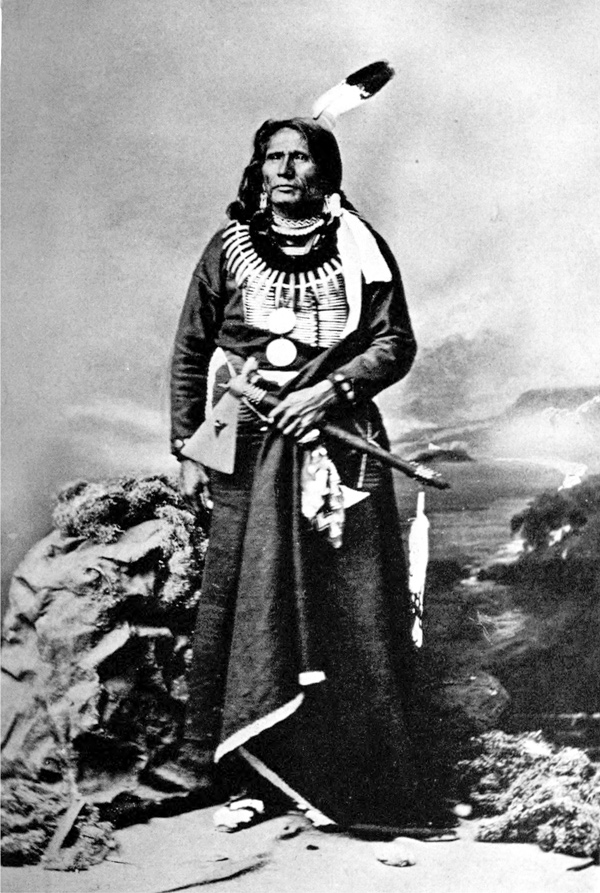 Chief Standing Bear with Missouri-style war axe and two eagle feathers