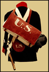 Red, painted knapsack over the back of a blue wool uniform coat