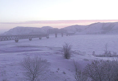 photo of bridge over icy river