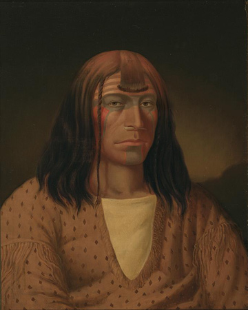 Male Indian with white bone running through his septum.